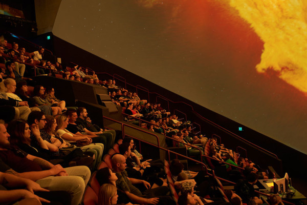 Adult audience watching a show in the planetarium.