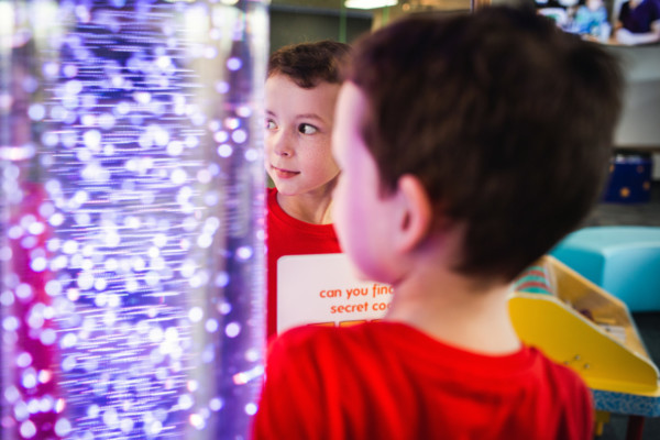 Reflection of a child looking at exhibit in Discoverland.