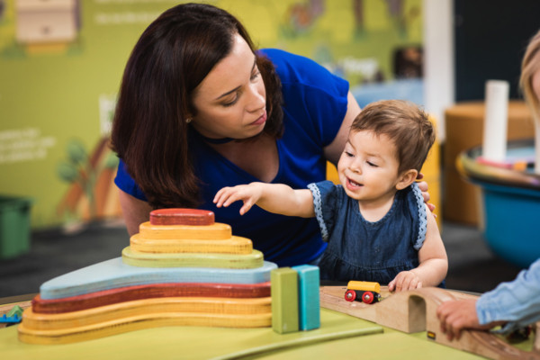 Young child and adult playing in Discoverland