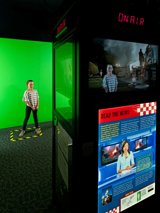 A young girl presenting a news segment in front of a green screen for the Rescue Exhibition.