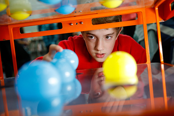 A close up of boy playing with ball toys