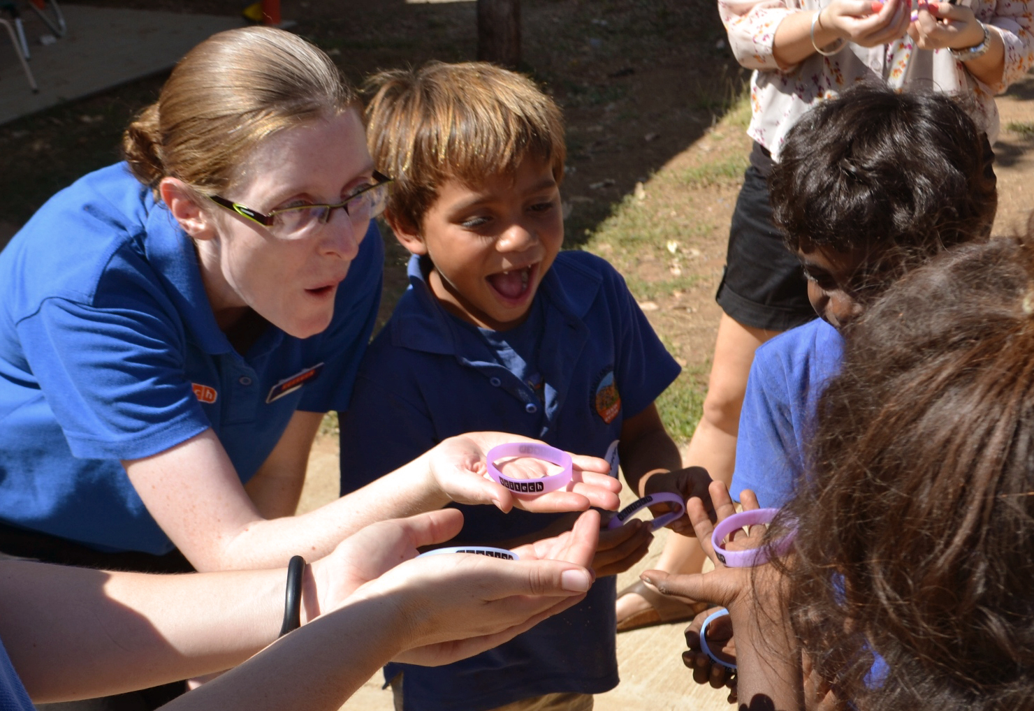 Scitech science presenter with young children holding scitech branded wristbands