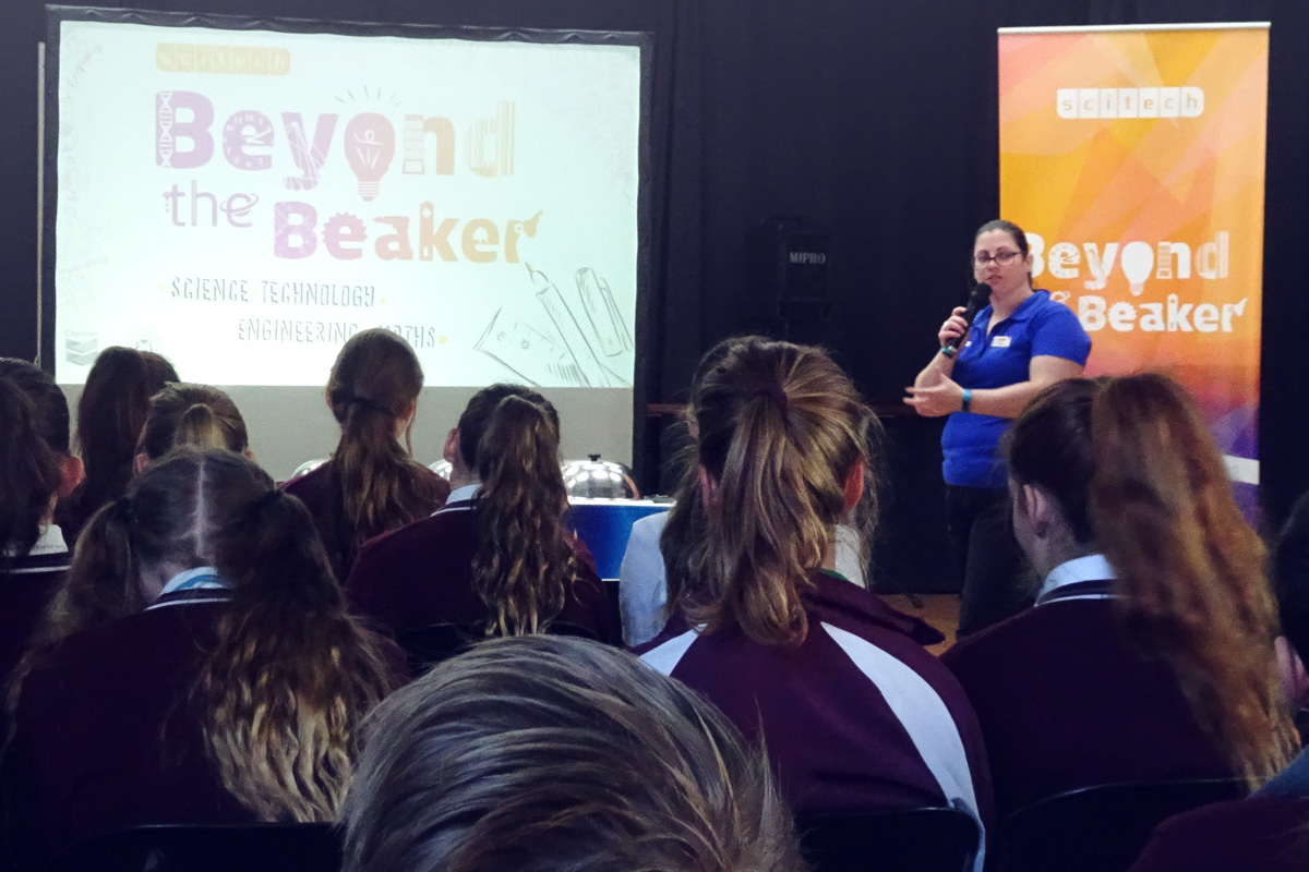 A scitech science presenter giving secondary students a STEM career presentation.