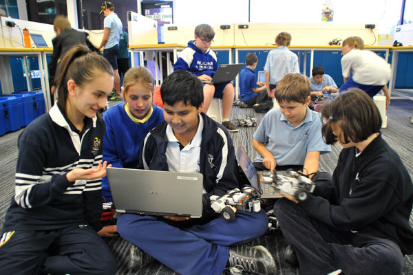 A group of students experimenting with robotics and coding in the classroom.