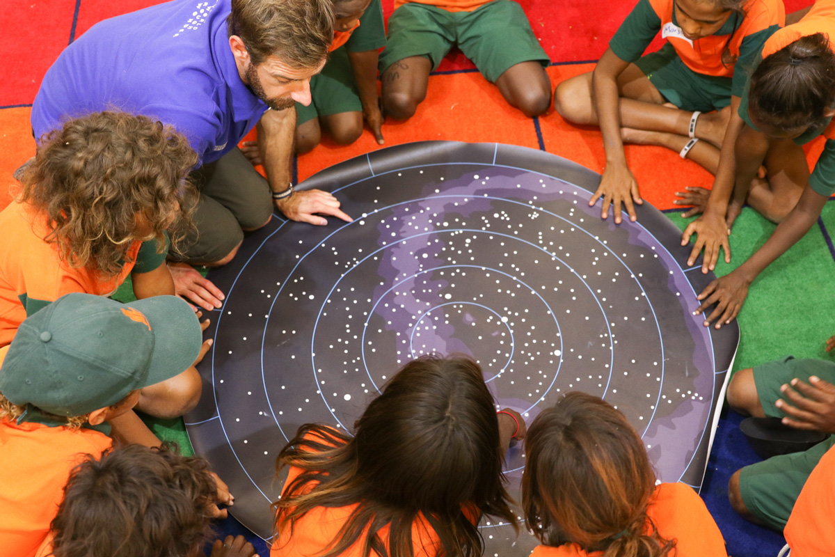 Aboriginal Education Program students look at a star map.