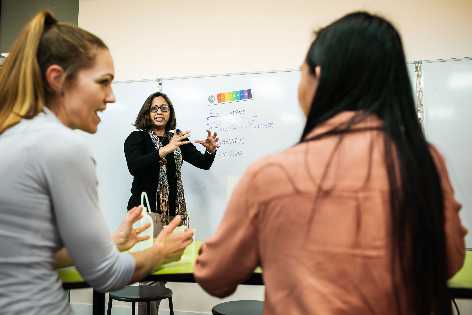 Teachers talking about science in a classroom.