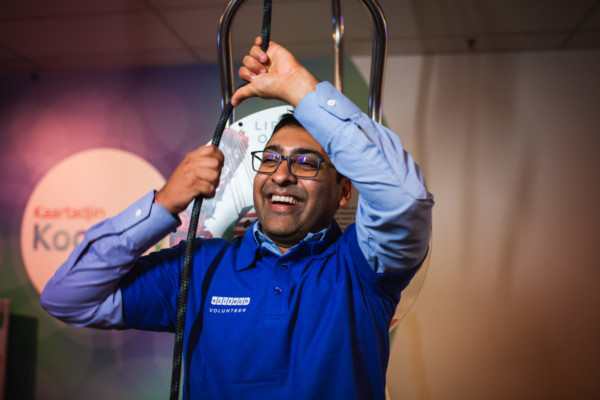 A Scitech volunteer playing with a 'lift' exhibit.