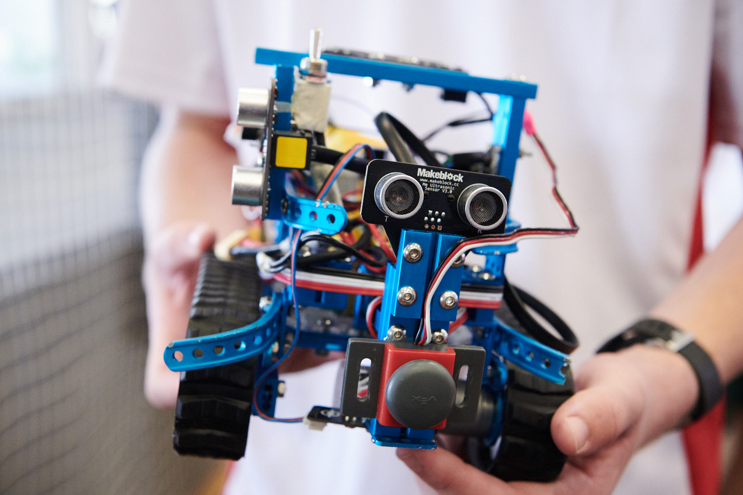 Student holds a RoboCup prototype.