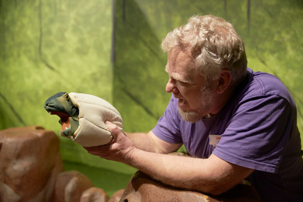 Puppeteer demonstrating baby dinosaur hand puppet