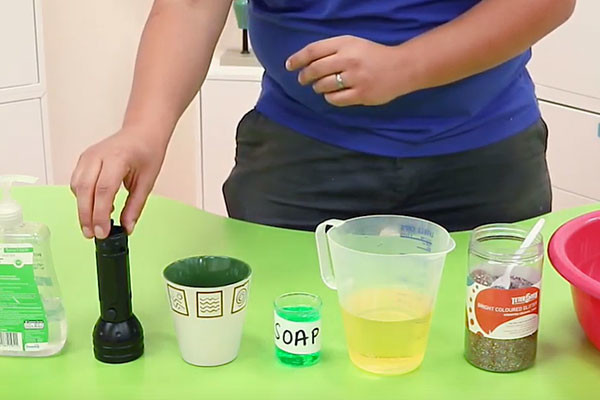 Presenter with ingredients on how to make effective soap at home.