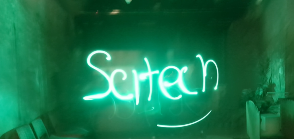 Scitech written in green light text.