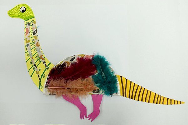 A craft dinosaur made of feathers and paper.