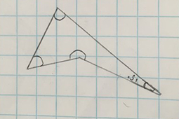 A drawing of a triangular shape with angles drawn in the corners on lined paper.