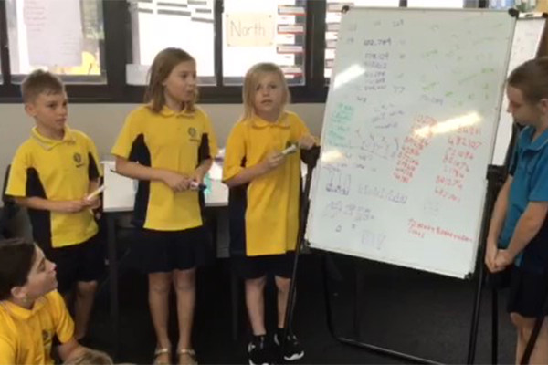 Makybe Rise Year 4 Primary School students solving maths problems as a group