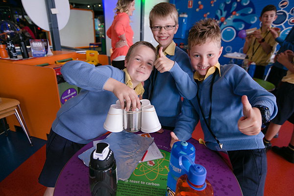 A team of three primary school students showing off their Challenge Day brainstorm activity