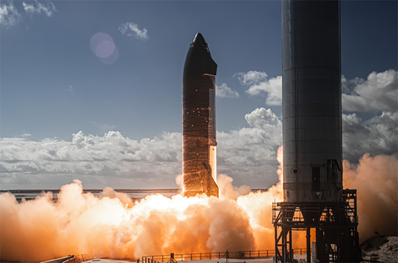 SpaceX's 6-engine static fire test of (regular) Starship; a tall rocket sits above a huge launch cloud 