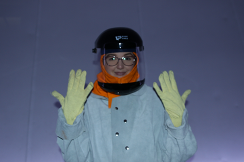 Planetarium presenter wearing full protective gear to change the xenon lamps in the projector