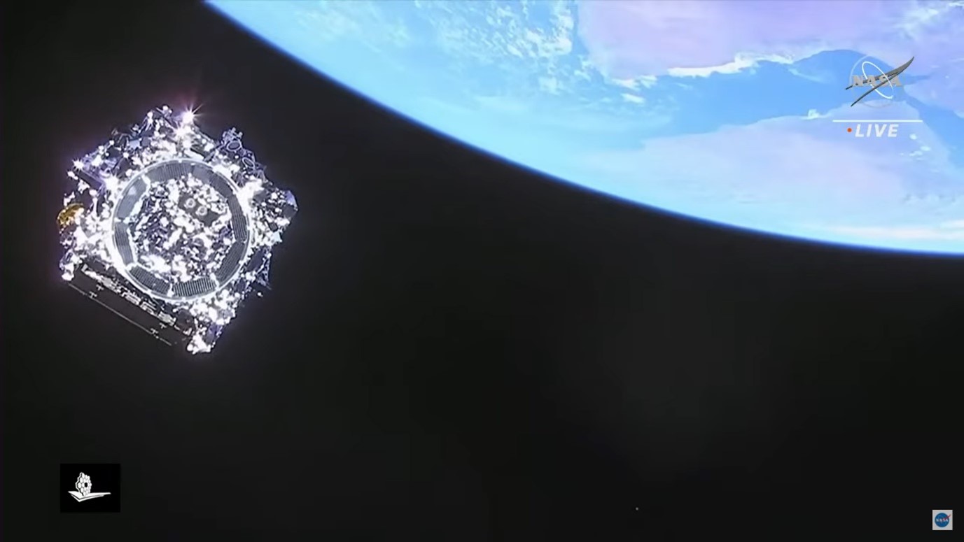 JWST disappearing into space moments after separating from the launch vehicle; Earth seen in the background distance