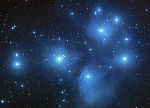 An astronomical image of the Pleiades, a group of more than 800 stars located about 410 light-years from Earth in the constellation Taurus