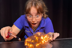 Scitech Science Communicator performing an experiment