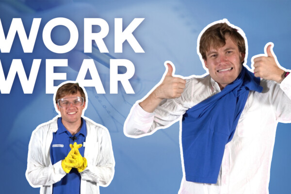 Steven wearing a lab coat and gloves, giving a thumbs up.