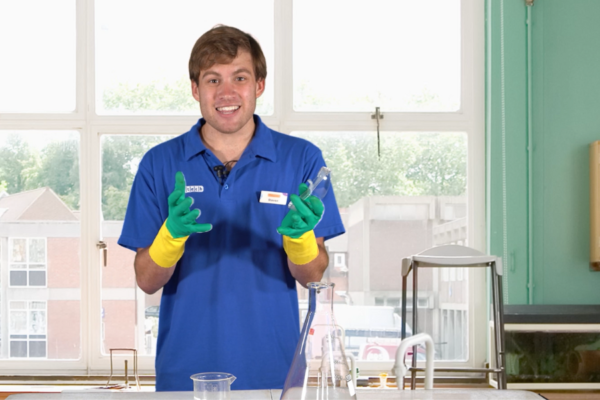 man wearing safety gloves and blue shirt for a science experiment