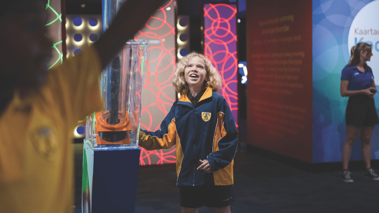 Primary school child interacting with an exhibit at Scitech while on excursion